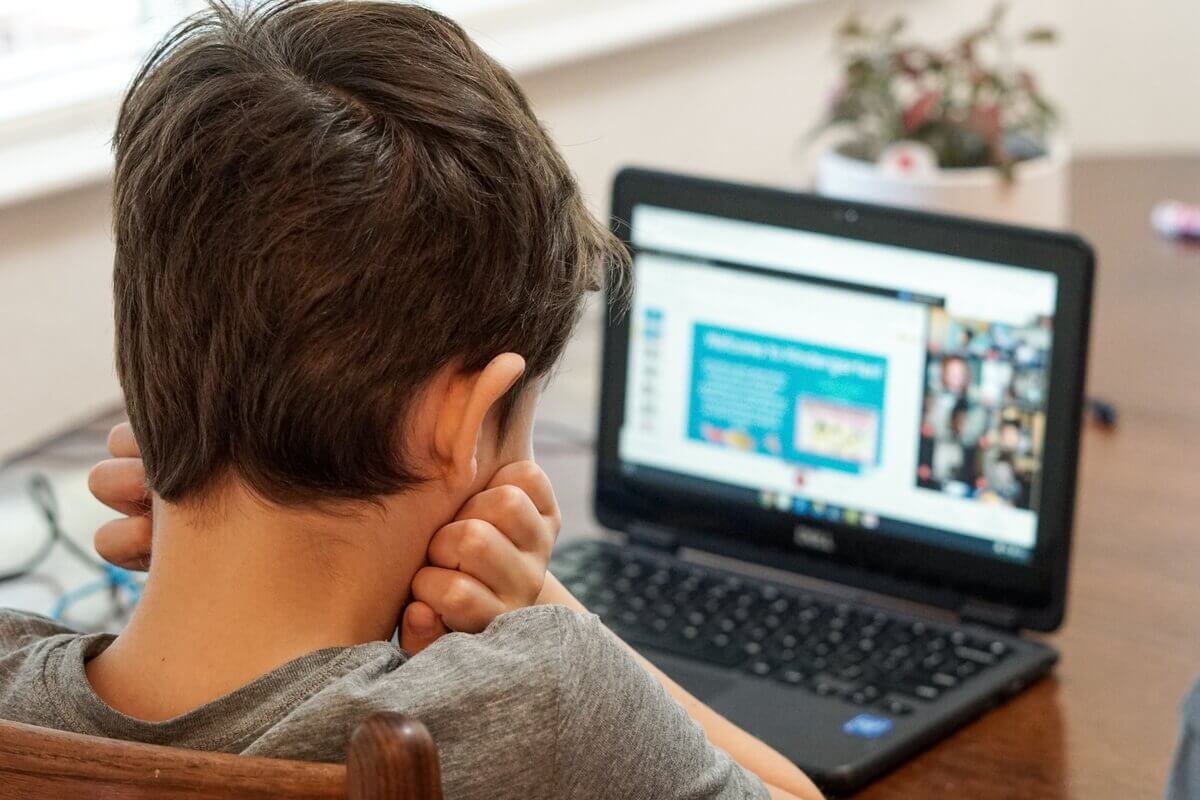 kid watching something on laptop